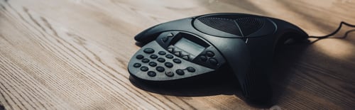 Preview: conference phone on wooden table at office