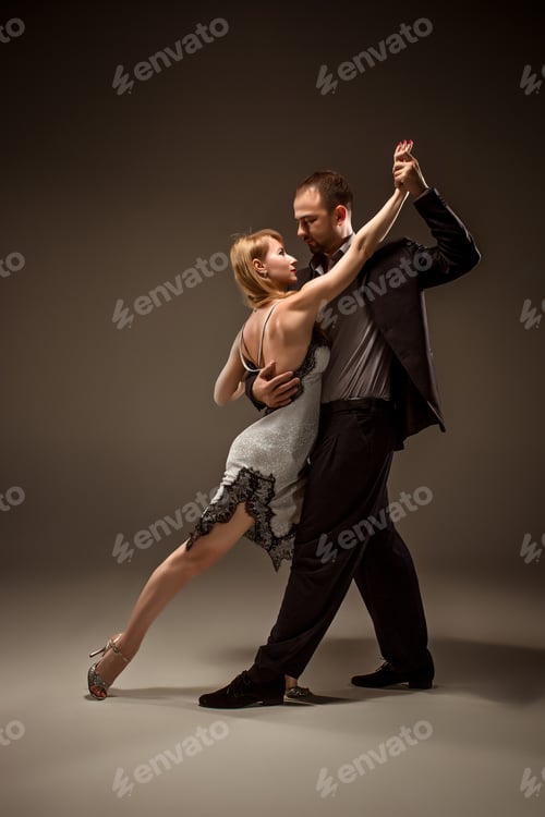 Preview: A Man And A Woman Dancing Argentinian Tango On Gray Studio Background