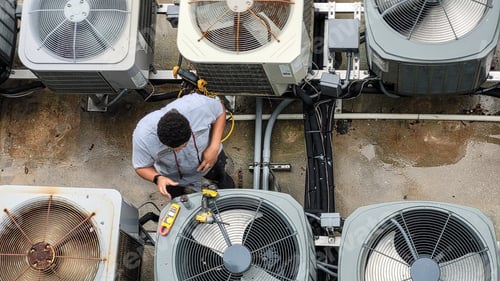 Preview: HVAC Technician Working on Commercial Air Conditioner System