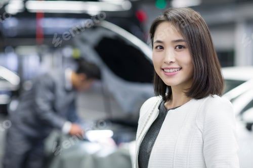 Preview: Young Chinese woman in repair shop with her car