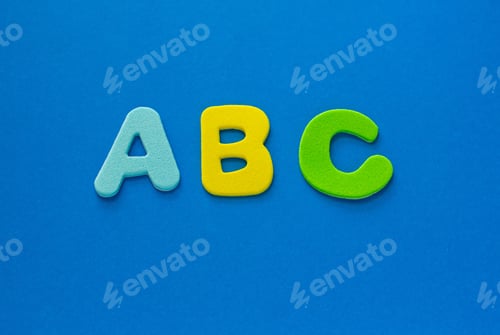 Preview: School begginnings. ABC colored letters on blue background, copy space