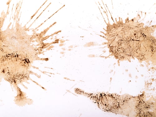 Preview: Light brown coffee splatters and streaks on a white background.