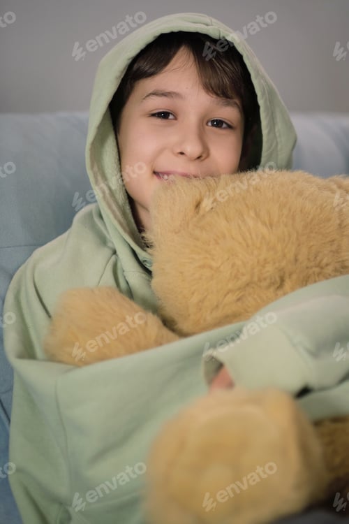 Preview: The boy embraces a soft teddy bear, evoking themes of childhood innocence and emotional connection.