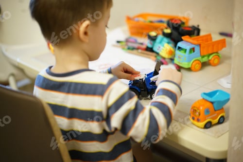Preview: 3 year old boy playing with toys and colorful pencils