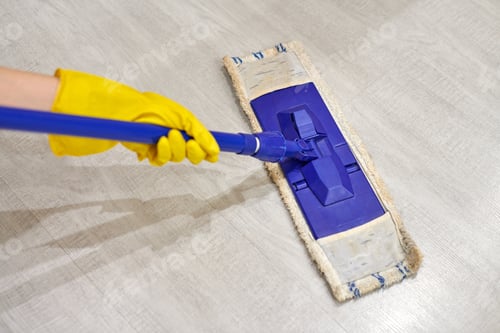 Preview: Girl in protective gloves cleaning floor using flat wet mop.