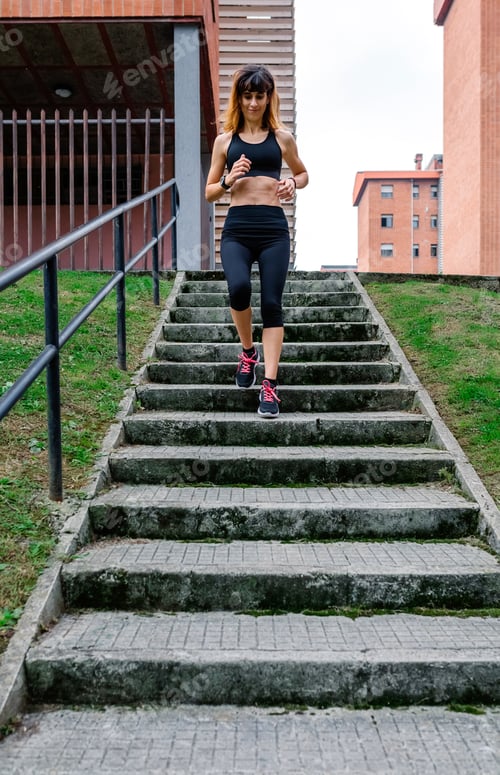 Preview: Female athlete going down stairs outdoors