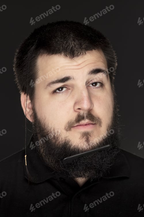 Preview: Funny Expressive Potrait Of Male, Wih Comb In His Beard.