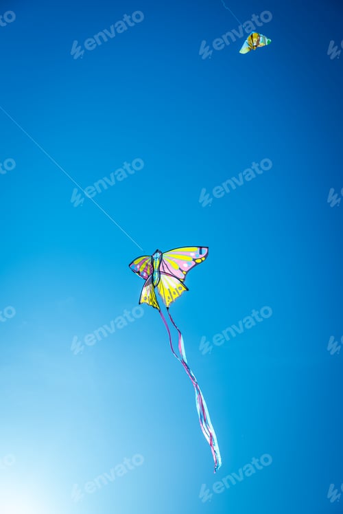 Preview: Several kites of summer children's games flying in the blue sky.