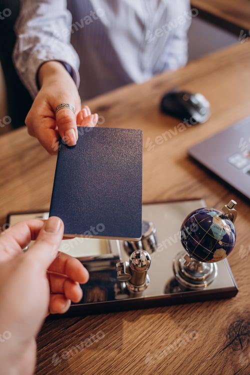 Preview: Agent giving passport and ticket to customer in the office of travel company