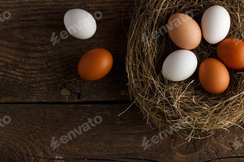 Preview: Fresh chicken eggs in a nest on a wooden background