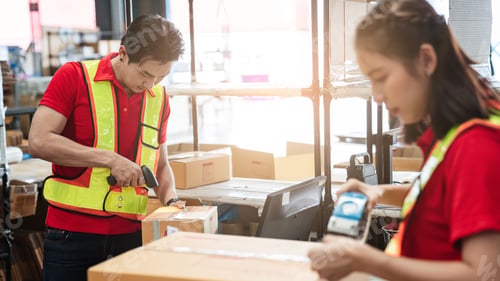 Preview: Warehouse worker checking details stock product and scanning a barcode on box package.