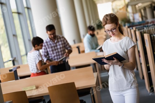 Preview: Group of happy young college students studying