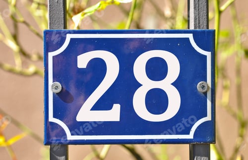 Preview: Closeup shot of a blue sign with the number 28 on the blurry background