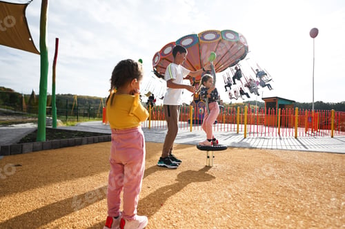 Preview: Children having fun in amusement park on sunny summer day. Kids playing outdoors.