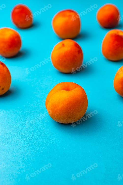 Preview: Symmetry of apricots with blue background.