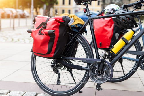 Preview: Many modern bicycles with travel luggage bags equipment parked in old european city center street
