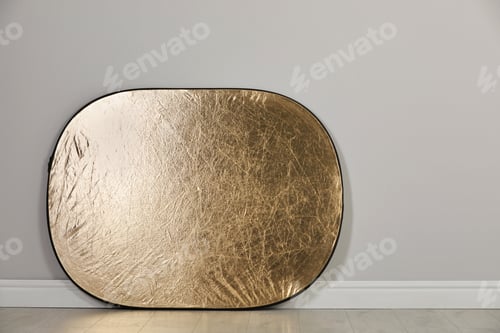 Preview: Studio reflector near grey wall in room, space for text. Professional photographer's equipment