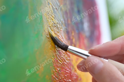Preview: Artist painting on canvas with brush, closeup
