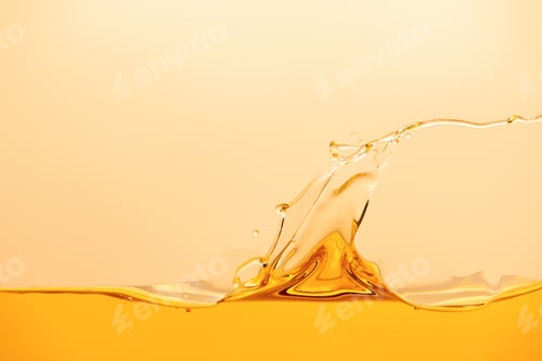 Preview: yellow bright liquid with splash and wave isolated on yellow