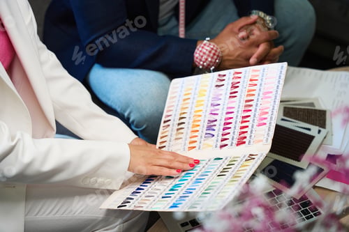 Preview: Fashion designer and clothier selecting color of threads