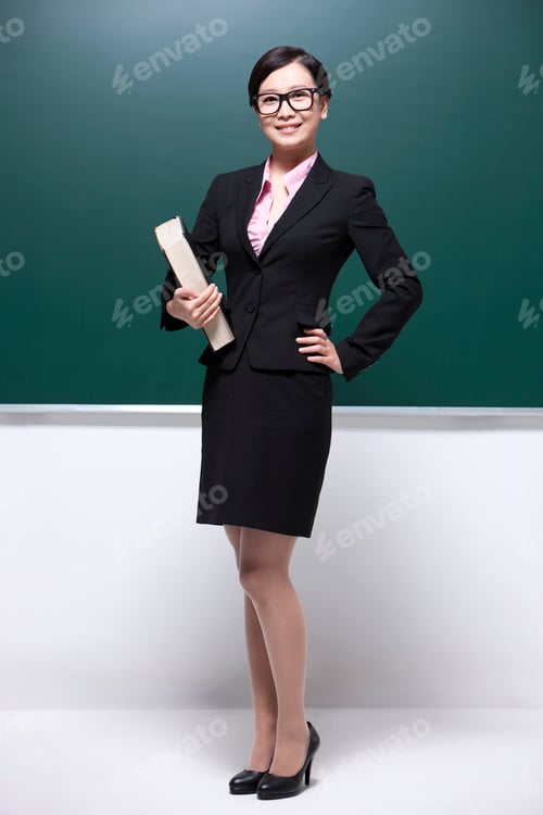 Preview: Professional female teacher hand on hip in classroom
