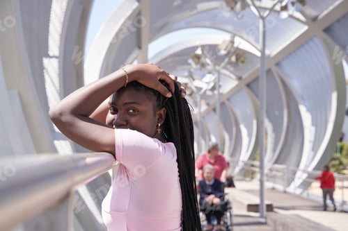 Preview: african american woman posing while looking at the camera with box braids