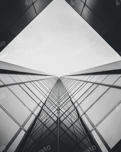 Preview: Vertical low angle greyscale shot of a modern building