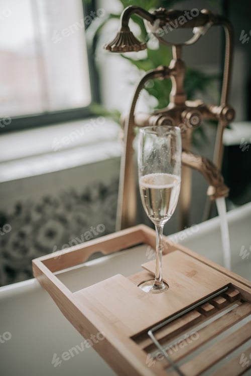 Preview: Luxury interior eco style modern bathroom with oval bathtub and champagne glass at natural lighting