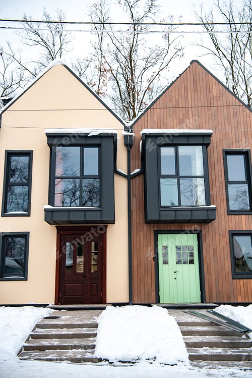 Preview: stylish modern buildings with snow on roofs near trees