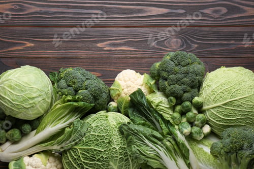 Preview: Many different types of fresh cabbage on wooden table, flat lay. Space for text