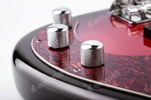 Preview: Metallic Volume Treble Guitar Bass Knobs. Electric Guitar. Red Electric Bass Guitar Close-Up