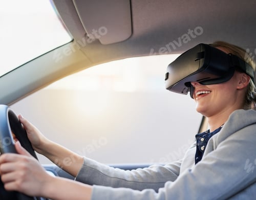 Preview: Cropped shot of a young businesswoman driving while wearing a virtual reality headset