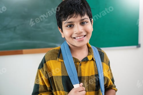 Preview: Portrait of cheerful young student wearing yellow checkered shirt