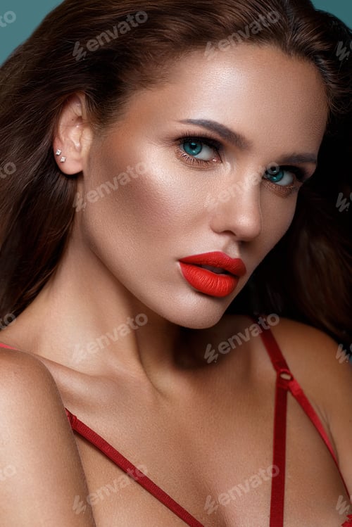 Preview: Beautiful sexy woman in a Hollywood manner with curls, natural makeup and red lips..