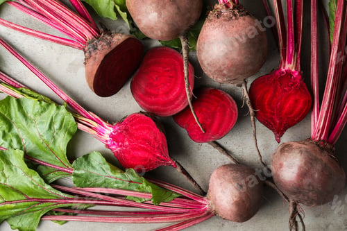 Preview: Cut and whole raw beets on light grey table, flat lay