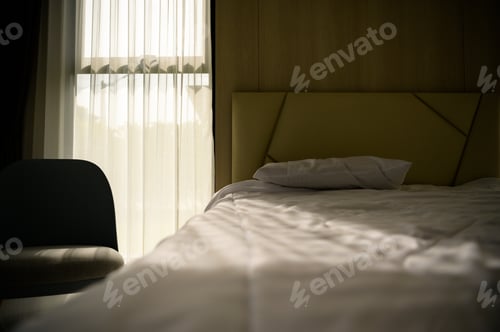 Preview: A bedroom showing the golden morning sun shining through the curtains