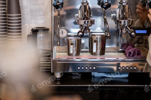 Preview: The barista prepares fresh coffee in the coffee machine in the morning