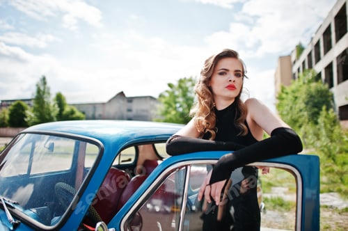 Preview: Girl model with bright makeup in retro style in vintage car