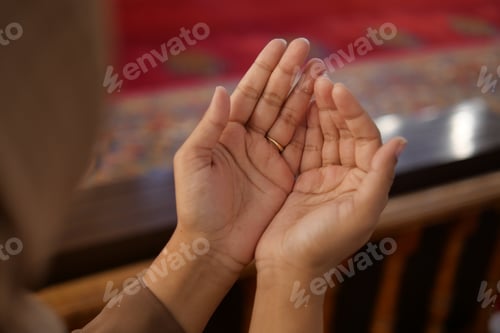 Preview: Muslim young woman in hijab is praying in mosque.