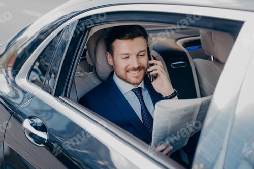 Preview: Well Dressed Man Talking on Phone in Car