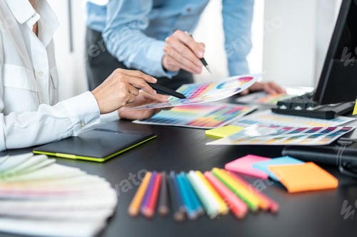 Preview: Two creative graphic designer team working on color selection and drawing on graphic tablet