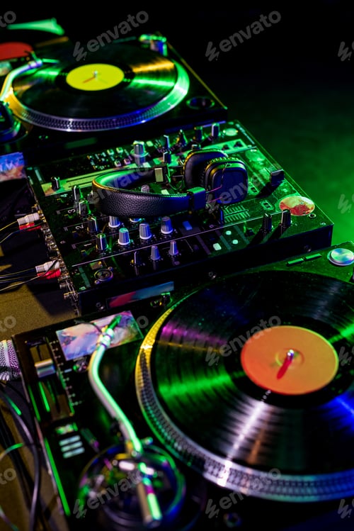 Preview: close up view of sound mixer with vinyl and headphones in nightclub