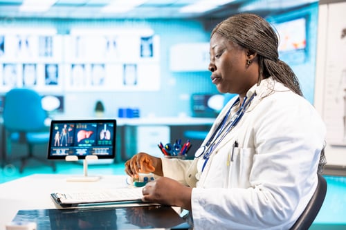 Preview: Female specialist using clinical scans and records to advise a patient