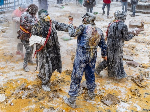 Preview: Ibi, Spain - December, 28 2018: People throwing eggs and flour at each other