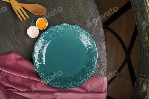 Preview: High angle shot of a green plate with an egg on the table
