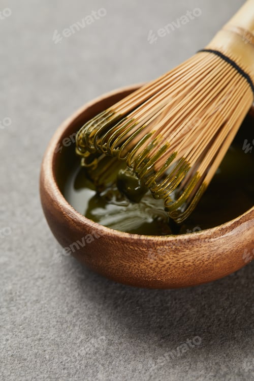 Preview: bamboo whisk in wooden bowl with matcha tea