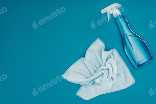 Preview: top view of blue rag and spray bottle isolated on blue