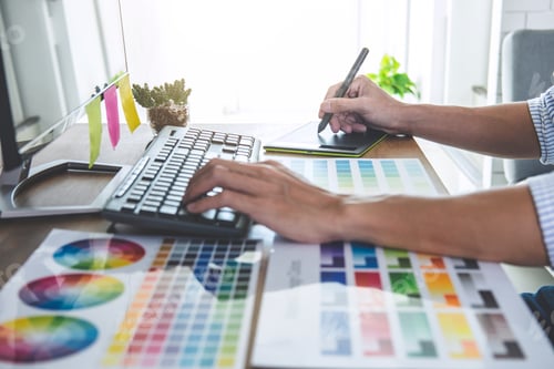 Preview: Image of male creative graphic designer working on color selection and drawing on graphics tablet at