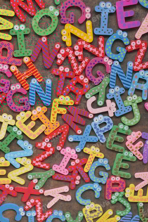 Preview: colorful plastic letters on white background, close up