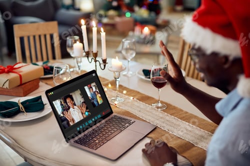 Preview: Close-up of happy black family having video call on Christmas day.